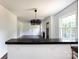 Bright living room with a modern chandelier, a breakfast bar, and hardwood floors at 2628 Clydesdale Ter, Charlotte, NC 28208