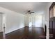 Spacious living room with hardwood floors, white walls, a ceiling fan, and ample natural light at 2628 Clydesdale Ter, Charlotte, NC 28208