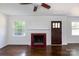 Living room with a decorative fireplace with red tile, hardwood floors, white walls, and natural light at 2628 Clydesdale Ter, Charlotte, NC 28208