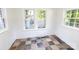 Sun room with natural light streaming through multiple windows and decorative, multi-toned tile flooring at 2628 Clydesdale Ter, Charlotte, NC 28208