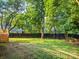 Lush backyard with a well-kept lawn, privacy fence, and mature trees providing shade at 3124 5Th Street Ne Pl, Hickory, NC 28601