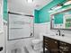 Updated bathroom with a marble tiled shower, white vanity, and modern fixtures at 3124 5Th Street Ne Pl, Hickory, NC 28601