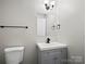 Well-lit bathroom with a modern vanity, faucet, and a sleek, black towel rack at 3124 5Th Street Ne Pl, Hickory, NC 28601
