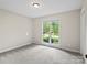 Cozy bedroom with neutral carpet and a view of the front yard through the window at 3124 5Th Street Ne Pl, Hickory, NC 28601