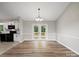 Bright dining room, located off of the kitchen, featuring a modern light fixture and a french door leading to the deck at 3124 5Th Street Ne Pl, Hickory, NC 28601