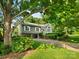 View of the exterior showing the manicured lawn, lovely tree, driveway and an attached two-car garage at 3124 5Th Street Ne Pl, Hickory, NC 28601