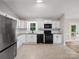 Spacious kitchen with stainless steel appliances, granite countertops, and tile flooring at 3124 5Th Street Ne Pl, Hickory, NC 28601