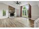 Bright living room features a stone fireplace and large windows with views of the landscaped yard at 3124 5Th Street Ne Pl, Hickory, NC 28601