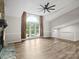Open living room features a stone fireplace and large windows with views of the landscaped yard at 3124 5Th Street Ne Pl, Hickory, NC 28601