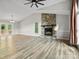Bright living room features a stone fireplace, large windows, and French doors leading to the deck at 3124 5Th Street Ne Pl, Hickory, NC 28601