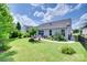 Spacious backyard with mature trees, landscaped gardens, and a patio at 3145 Bridgewater St, Lancaster, SC 29720