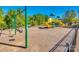 Community playground featuring a slide, bucket swings, and a bench nestled amongst the trees at 3145 Bridgewater St, Lancaster, SC 29720