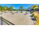 Community pool with splash area, palm trees, and seating, all enclosed by a black metal fence at 3145 Bridgewater St, Lancaster, SC 29720