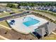 Aerial view of a community pool with a clubhouse, parking, and landscaping at 3145 Bridgewater St, Lancaster, SC 29720