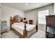 This bedroom offers a patterned comforter, natural light, and a dark wood bed frame at 322 Olympia Way, York, SC 29745