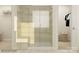 Contemporary bathroom featuring a glass-enclosed shower, neutral tile, and accessible storage solutions at 3887 Horsham St, Indian Land, SC 29707