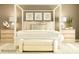 Beautifully decorated bedroom with a four-poster bed, bench seating, and coordinating side tables with lamps at 3887 Horsham St, Indian Land, SC 29707