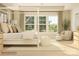 Bright bedroom with a four-poster bed, large windows, and cozy seating area for ultimate relaxation at 3887 Horsham St, Indian Land, SC 29707