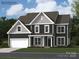 Beautiful two-story home featuring a well-manicured lawn and a two-car garage at 3887 Horsham St, Indian Land, SC 29707