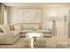 Comfortable living room featuring a sectional sofa, modern lighting, and stylish decor at 3887 Horsham St, Indian Land, SC 29707