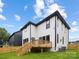 Exterior features a spacious backyard with a wood deck, lush green lawn and privacy fence at 3903 Plainview Rd, Charlotte, NC 28208