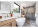 Spa bathroom with a soaking tub, glass-enclosed shower, double vanity and modern fixtures at 3903 Plainview Rd, Charlotte, NC 28208