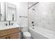 Bathroom with tiled tub, shower combination, single vanity, and neutral finishes at 3903 Plainview Rd, Charlotte, NC 28208