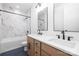 Elegant bathroom features a double vanity, granite countertops, and a tub-shower combination with marble tile at 3903 Plainview Rd, Charlotte, NC 28208