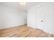 Neutral bedroom features hardwood floors, white walls, and two closets for ample storage at 3903 Plainview Rd, Charlotte, NC 28208