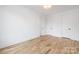 Neutral bedroom features hardwood floors, white walls, and three closets for ample storage at 3903 Plainview Rd, Charlotte, NC 28208