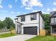 Charming two-story home featuring a modern design, black trim and a well-manicured front yard at 3903 Plainview Rd, Charlotte, NC 28208