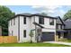 A modern two-story home stands on a lush green lawn with a driveway and well-kept landscaping at 3903 Plainview Rd, Charlotte, NC 28208
