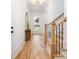 Inviting foyer features hardwood floors, a staircase with black iron spindles, and a glass-paneled front door at 3903 Plainview Rd, Charlotte, NC 28208