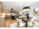 Bright and open kitchen with a large island, stainless steel appliances, and dining area nearby at 3903 Plainview Rd, Charlotte, NC 28208