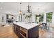 Well-designed kitchen flows into the dining and living areas, featuring a large island, stainless steel appliances at 3903 Plainview Rd, Charlotte, NC 28208