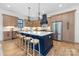 Spacious kitchen boasts a large island with barstool seating, custom cabinetry, and modern stainless appliances at 3903 Plainview Rd, Charlotte, NC 28208