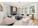 Bright living room boasts a modern fireplace, contemporary chandelier, and ample natural light from black-framed windows at 3903 Plainview Rd, Charlotte, NC 28208