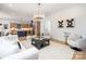 Open-concept living area flows into the kitchen with a stylish blue island and stainless steel appliances at 3903 Plainview Rd, Charlotte, NC 28208