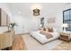 Bright main bedroom with a textured bed frame, wood floors, and modern lighting fixture at 3903 Plainview Rd, Charlotte, NC 28208