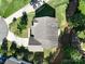 Aerial view of a house showing the roof, backyard, and driveway surrounded by lush greenery and neighboring houses at 4003 Fine Robe Dr, Indian Trail, NC 28079
