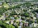 Wide aerial perspective showcasing a suburban neighborhood with lush greenery and numerous residential houses at 4003 Fine Robe Dr, Indian Trail, NC 28079
