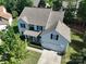 Aerial view of a two-story home with a well-maintained yard, mature trees, and a classic roof design at 4003 Fine Robe Dr, Indian Trail, NC 28079