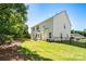 Spacious backyard with a black metal fence, lush lawn, patio, and ample space for outdoor activities at 4003 Fine Robe Dr, Indian Trail, NC 28079