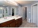 Well-lit bathroom featuring double sinks, vanity, shower, and separate water closet at 4003 Fine Robe Dr, Indian Trail, NC 28079