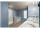 Bright bathroom featuring a glass-enclosed shower, soaking tub, and double sink vanity at 4003 Fine Robe Dr, Indian Trail, NC 28079