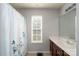 Well-lit bathroom with a vanity and white shower curtain, offering a clean and functional space at 4003 Fine Robe Dr, Indian Trail, NC 28079