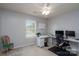 Bright bedroom featuring a ceiling fan, white desk, and a chair, perfect for a home office space at 4003 Fine Robe Dr, Indian Trail, NC 28079
