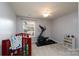 A bright bedroom with a ceiling fan, crib, and exercise machine; perfect for a growing Gathering at 4003 Fine Robe Dr, Indian Trail, NC 28079