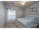 Bright bedroom with a decorative bed, ceiling fan, and window with ruffled curtains at 4003 Fine Robe Dr, Indian Trail, NC 28079