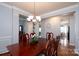 Formal dining room boasts elegant trim and a classic chandelier, perfect for entertaining at 4003 Fine Robe Dr, Indian Trail, NC 28079